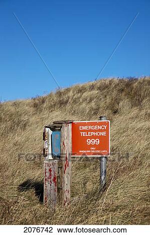 Stock Image - An emergency telephone on a grassy hill; northumberland england. Fotosearch