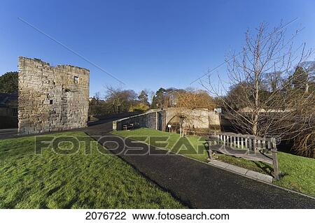 An old stone wall along a path leading over a bridge across a river; warkworth northumberland england View Large Photo Image Stock Image - An old stone wall along a path leading over a bridge across a river; warkworth northumberland england. Fotosearch