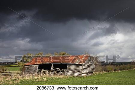 An old wooden barn under storm clouds; yorkshire england View Large Photo Image Stock Image - An old wooden barn under storm clouds; yorkshire england. Fotosearch