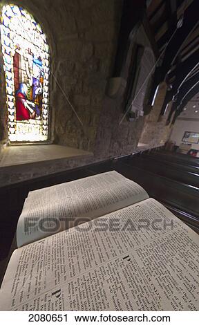 An open bible on a podium and a stained glass window in st. mary's church; holystone northumberland england View Large Photo Image Stock Image - An open bible on a podium and a stained glass window in st. mary's church; holystone northumberland england. Fotosearch