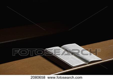 Stock Photo - An open bible on a wooden ledge; howick northumberland england. Fotosearch