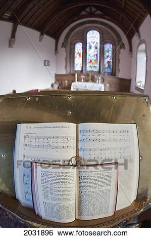 Stock Photograph - An Open Hymnal And Bible On A Podium Inside A Church; Northumberland England. Fotosearch