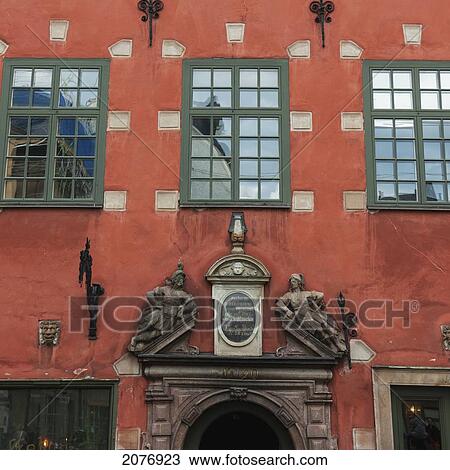 An orange building with sculptures above the doorway in old town; stockholm sweden View Large Photo Image Stock Image - An orange building with sculptures above the doorway in old town; stockholm sweden. Fotosearch