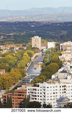 Stock Image - Apartment blocks in western area of the city manzanares river and parklands; madrid spain. Fotosearch