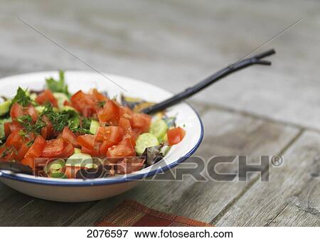 Bowl of salad on a wooden table; lake of the woods ontario canada View Large Photo Image Stock Photo - Bowl of salad on a wooden table; lake of the woods ontario canada. Fotosearch