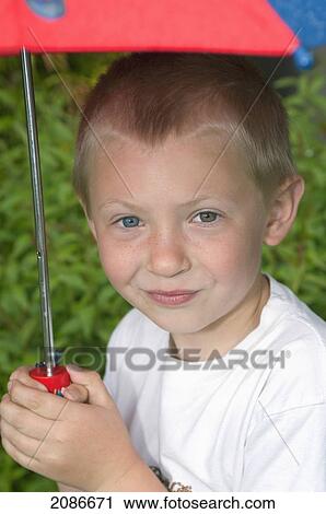 Boy holding an umbrella outside; moraga california united states of america View Large Photo Image Stock Image - Boy holding an umbrella outside; moraga california united states of america. Fotosearch