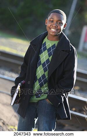 Boy Holding School Books Wearing Green Argyle Sweater And Pea Coat; View Large Photo Image Stock Image - Boy Holding School Books Wearing Green Argyle Sweater And Pea Coat;. Fotosearch