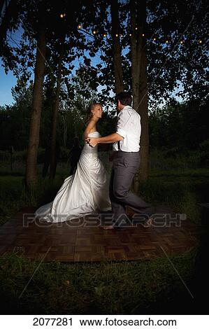 Bride and groom dancing at dusk on an illuminated dance floor; vancouver british columbia canada View Large Photo Image Stock Image - Bride and groom dancing at dusk on an illuminated dance floor; vancouver british columbia canada. Fotosearch