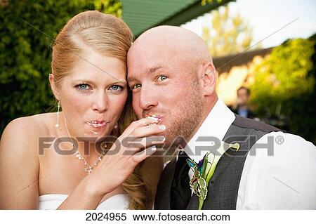 Bride And Groom Feed Cake To Each Other; Grand Junction Colorado United States Of America View Large Photo Image Stock Photography - Bride And Groom Feed Cake To Each Other; Grand Junction Colorado United States Of America. Fotosearch