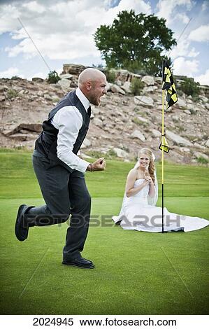 Bride And Groom Joke Around On Golf Course; Grand Junction Colorado United States Of America View Large Photo Image Stock Photography - Bride And Groom Joke Around On Golf Course; Grand Junction Colorado United States Of America. Fotosearch