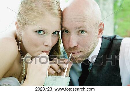 Bride And Groom Sipping Through Straws From The Same Glass; Grand Junction Colorado United States Of America View Large Photo Image Stock Image - Bride And Groom Sipping Through Straws From The Same Glass; Grand Junction Colorado United States Of America. Fotosearch
