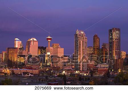 Calgary Skyline At Dawn With City Lights And Deep Blue Sky With Buildings Reflecting The Orange Glow Of Sunrise; Calgary Alberta Canada View Large Photo Image Stock Photo - Calgary Skyline At Dawn With City Lights And Deep Blue Sky With Buildings Reflecting The Orange Glow Of Sunrise; Calgary Alberta Canada. Fotosearch