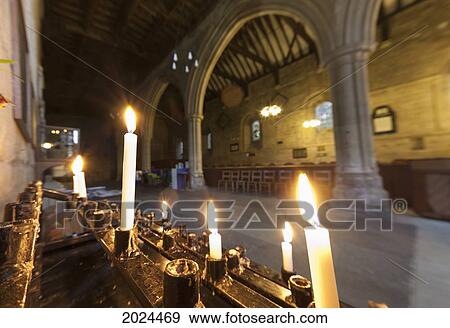 Stock Photo - Candles Lit Inside A Church Building; Northumberland England. Fotosearch