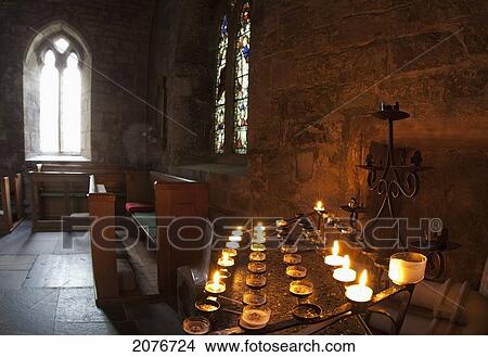 Picture - Candles lit inside a church sanctuary; bamburgh northumberland england. Fotosearch
