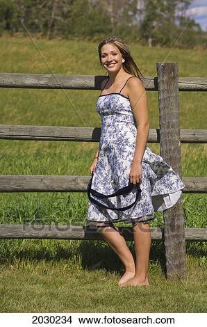 City Girl Standing By A Farm Fence; Edmonton Alberta Canada View Large Photo Image Picture - City Girl Standing By A Farm Fence; Edmonton Alberta Canada. Fotosearch