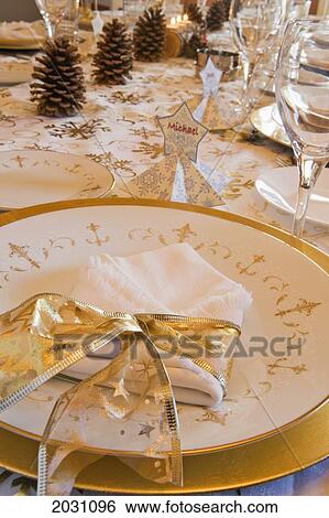 Close Up Of A Classy Christmas Table Setting With Gold Ribbon Around A Cloth Napkin On A Gold Rimmed Plate And Pine Cones In The Background; Calgary Alberta Canada View Large Photo Image Stock Photograph - Close Up Of A Classy Christmas Table Setting With Gold Ribbon Around A Cloth Napkin On A Gold Rimmed Plate And Pine Cones In The Background; Calgary Alberta Canada. Fotosearch