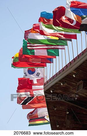 Stock Image - Close up of flags of countries of the world on top of a building; port colborne ontario canada. Fotosearch