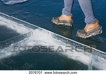 Close up of the boots of a female walking on a frozen mountain lake with ice cracks; alberta canada View Large Photo Image Stock Image - Close up of the boots of a female walking on a frozen mountain lake with ice cracks; alberta canada. Fotosearch