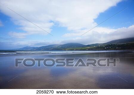Stock Image - Clouds Reflected On The Wet Sand Of Inch Beach In Dingle; Inch County Kerry Ireland. Fotosearch