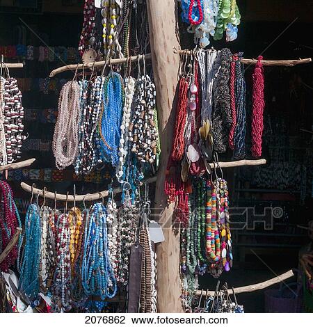 Stock Image - Colourful jewelry hanging on display; sayulita mexico. Fotosearch