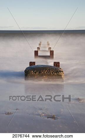 Concrete and wooden posts immersed in water and mist; northumberland england View Large Photo Image Picture - Concrete and wooden posts immersed in water and mist; northumberland england. Fotosearch