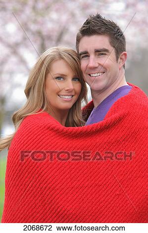 Couple Cuddled Up In A Red Blanket Looking At The Camera; Portland Oregon United States Of America View Large Photo Image Stock Image - Couple Cuddled Up In A Red Blanket Looking At The Camera; Portland Oregon United States Of America. Fotosearch