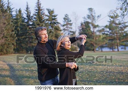 Couple Dancing In A Park; St. Albert Alberta Canada View Large Photo Image Stock Photograph - Couple Dancing In A Park; St. Albert Alberta Canada. Fotosearch