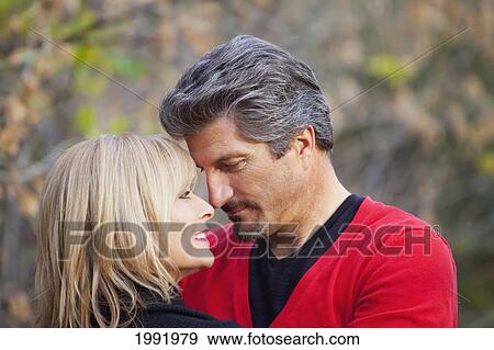 Stock Photo - Couple Embracing And Spending Quality Time Together In A Park In Autumn; St. Albert Alberta Canada. Fotosearch