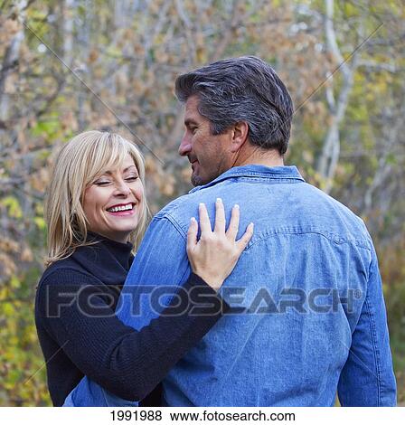 Stock Photo - Couple Embracing And Spending Quality Time Together In A Park In Autumn; St. Albert Alberta Canada. Fotosearch