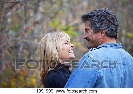 Stock Photo - Couple Embracing And Spending Quality Time Together In A Park In Autumn; St. Albert Alberta Canada. Fotosearch