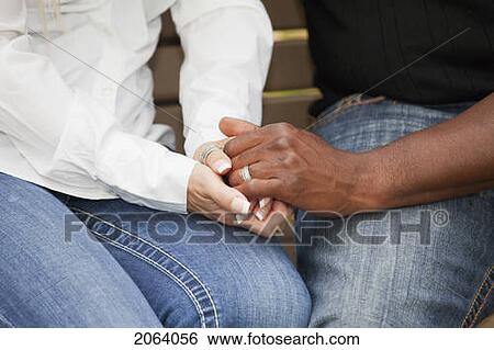 Couple Holding Hands On A Park Bench; Edmonton Alberta Canada View Large Photo Image Stock Photograph - Couple Holding Hands On A Park Bench; Edmonton Alberta Canada. Fotosearch