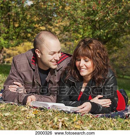 Couple Reading The Bible Together In A Park; Edmonton Alberta Canada View Large Photo Image Stock Photograph - Couple Reading The Bible Together In A Park; Edmonton Alberta Canada. Fotosearch