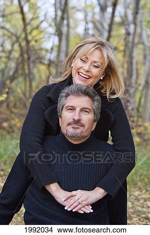 Couple Spending Quality Time Together In A Park In Autumn; St. Albert Alberta Canada View Large Photo Image Picture - Couple Spending Quality Time Together In A Park In Autumn; St. Albert Alberta Canada. Fotosearch