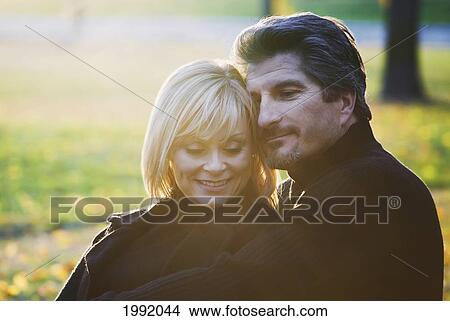 Couple Spending Quality Time Together In A Park In Autumn; St. Albert Alberta Canada View Large Photo Image Picture - Couple Spending Quality Time Together In A Park In Autumn; St. Albert Alberta Canada. Fotosearch