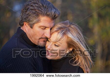 Couple Spending Quality Time Together In A Park In Autumn; St. Albert Alberta Canada View Large Photo Image Picture - Couple Spending Quality Time Together In A Park In Autumn; St. Albert Alberta Canada. Fotosearch