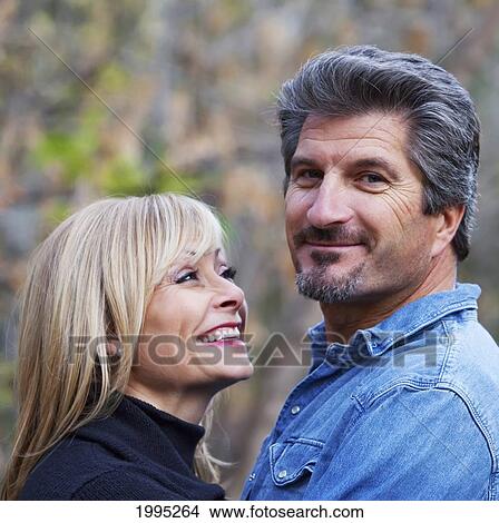 Picture - Couple Spending Quality Time Together In A Park In Autumn; St. Albert Alberta Canada. Fotosearch