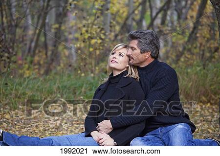 Couple Spending Quality Time Together In A Park In Autumn; St. Albert Alberta Canada View Large Photo Image Stock Image - Couple Spending Quality Time Together In A Park In Autumn; St. Albert Alberta Canada. Fotosearch