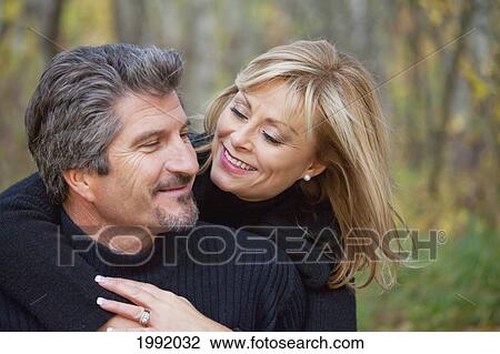 Stock Image - Couple Spending Quality Time Together In A Park In Autumn; St. Albert Alberta Canada. Fotosearch