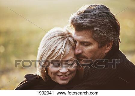 Couple Spending Quality Time Together In A Park In Autumn; St. Albert Alberta Canada View Large Photo Image Stock Image - Couple Spending Quality Time Together In A Park In Autumn; St. Albert Alberta Canada. Fotosearch