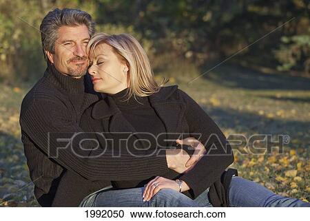 Couple Spending Quality Time Together In A Park In Autumn; St. Albert Alberta Canada View Large Photo Image Stock Image - Couple Spending Quality Time Together In A Park In Autumn; St. Albert Alberta Canada. Fotosearch