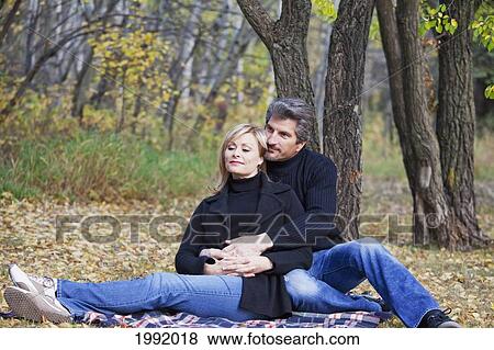 Couple Spending Quality Time Together In A Park In Autumn; St. Albert Alberta Canada View Large Photo Image Stock Photo - Couple Spending Quality Time Together In A Park In Autumn; St. Albert Alberta Canada. Fotosearch