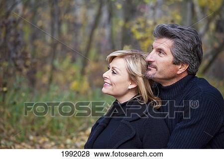 Couple Spending Quality Time Together In A Park In Autumn; St. Albert Alberta Canada View Large Photo Image Stock Photo - Couple Spending Quality Time Together In A Park In Autumn; St. Albert Alberta Canada. Fotosearch