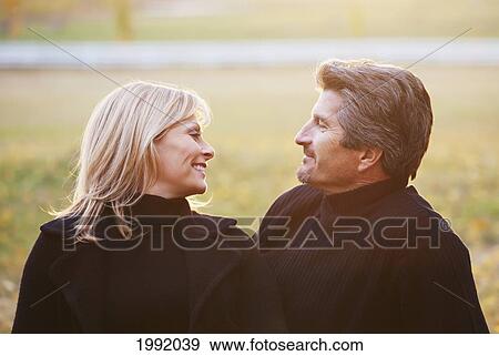 Couple Spending Quality Time Together In A Park In Autumn; St. Albert Alberta Canada View Large Photo Image Stock Photo - Couple Spending Quality Time Together In A Park In Autumn; St. Albert Alberta Canada. Fotosearch