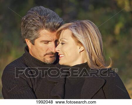 Couple Spending Quality Time Together In A Park In Autumn; St. Albert Alberta Canada View Large Photo Image Stock Photo - Couple Spending Quality Time Together In A Park In Autumn; St. Albert Alberta Canada. Fotosearch