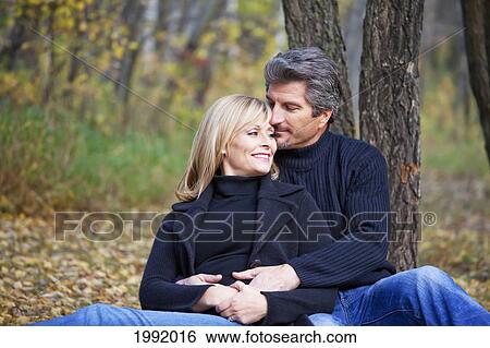 Couple Spending Quality Time Together In A Park In Autumn; St. Albert Alberta Canada View Large Photo Image Stock Photograph - Couple Spending Quality Time Together In A Park In Autumn; St. Albert Alberta Canada. Fotosearch