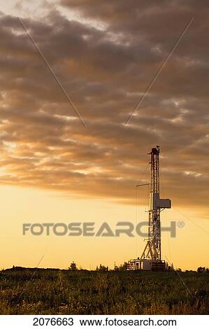 Drilling rig with dramatic clouds at sunrise east of fort saskatchewan; alberta canada View Large Photo Image Stock Image - Drilling rig with dramatic clouds at sunrise east of fort saskatchewan; alberta canada. Fotosearch