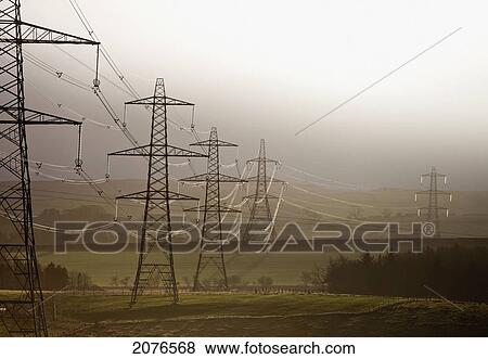 Electrical transmission towers and lines in a row across fields; northumberland england View Large Photo Image Stock Photo - Electrical transmission towers and lines in a row across fields; northumberland england. Fotosearch