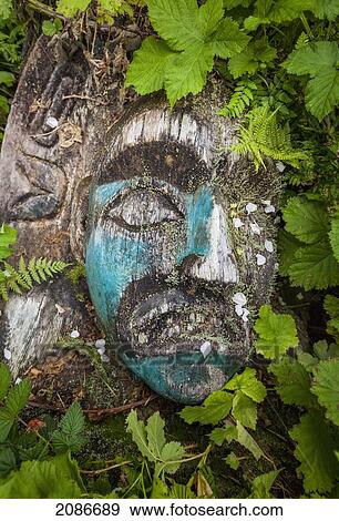 Stock Photo - Fallen totem in friendly cove in a blackberry bush; yuquot west vancouver island british columbia canada. Fotosearch