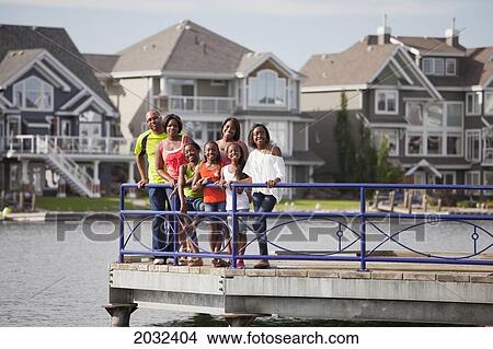 Family On A Pier In A Residential Lake Community; Edmonton Alberta Canada View Large Photo Image Picture - Family On A Pier In A Residential Lake Community; Edmonton Alberta Canada. Fotosearch