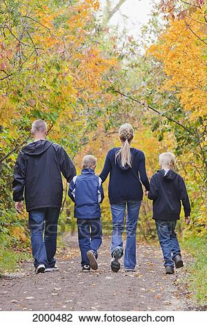 Stock Image - Family Walking Together On A Path In A Park In Autumn; Edmonton Alberta Canada. Fotosearch